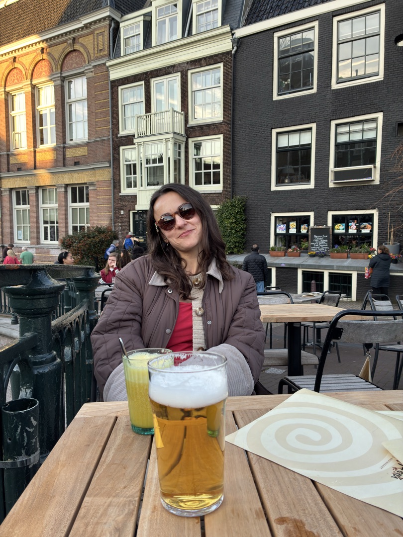 Konxhe at a terrace café in Amsterdam with a beer in the foreground
